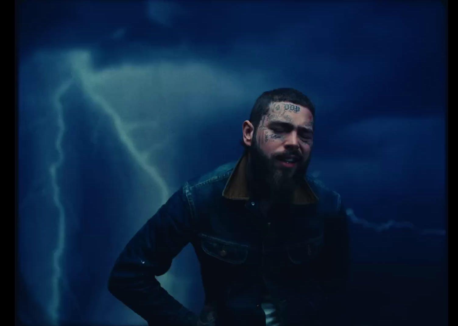 a man standing in front of a storm with his hands on his hips