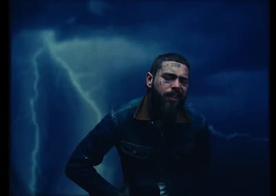 a man standing in front of a storm with his hands on his hips