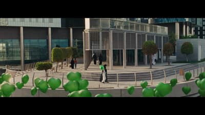 a group of people walking down a street next to a building
