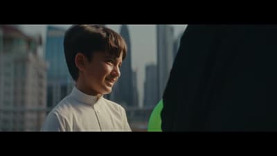 a boy in a white shirt and a green frisbee