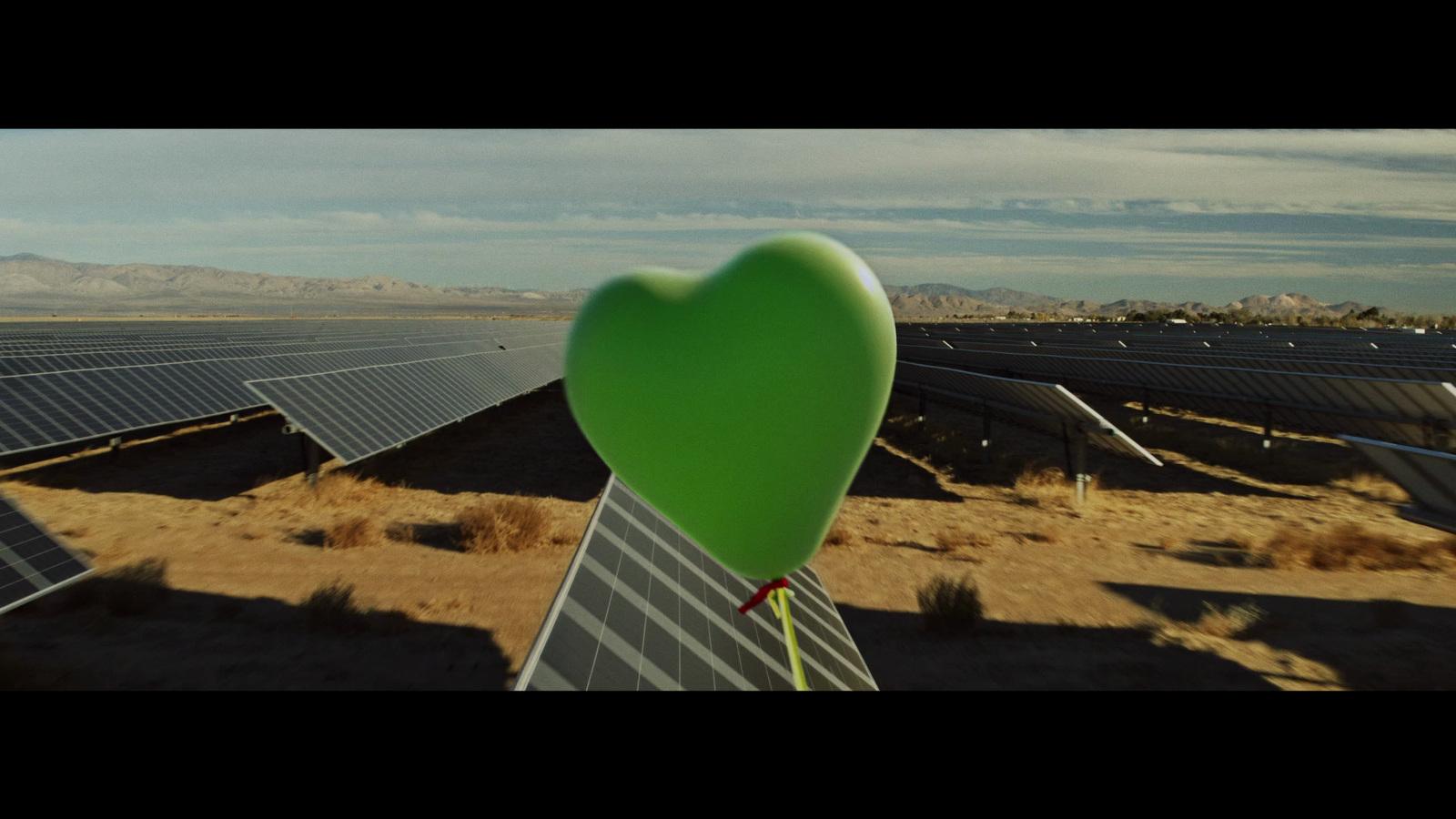 a heart shaped balloon in the middle of a desert