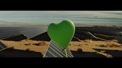 a heart shaped balloon in the middle of a desert