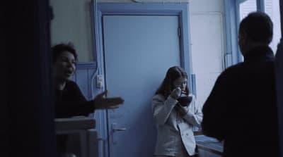 a woman standing next to a man in a room