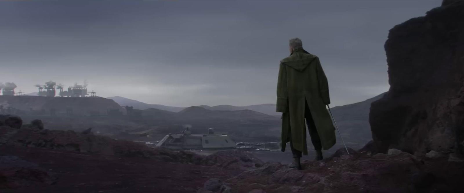 a man standing on top of a rocky hillside