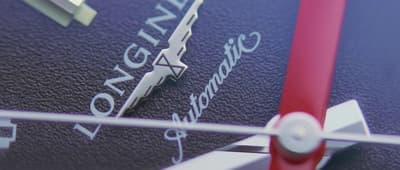 a close up of a blue and red clock