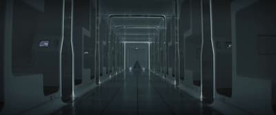 a long hallway with a person walking down it