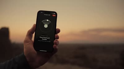 a person holding a cell phone in their hand
