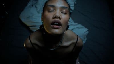 a woman laying on a bed with her eyes closed