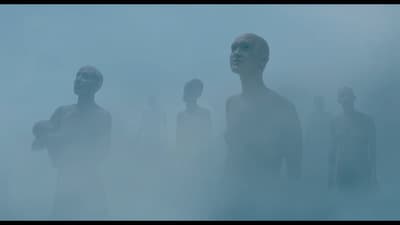 a group of people standing in a foggy area