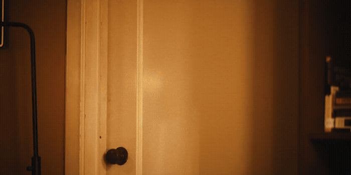 a door is open in a dimly lit room
