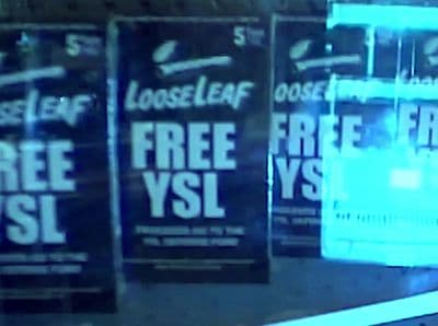 a store front window with free vsl signs on it