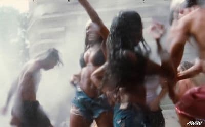 a group of naked people dancing in the street