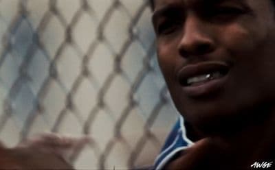 a close up of a person near a fence