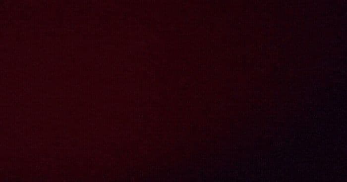 a clock is shown on a dark red background