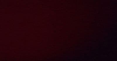a clock is shown on a dark red background