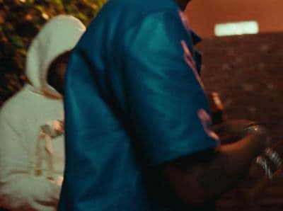 a man in a blue shirt and a white backpack
