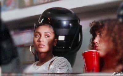 a woman with a helmet on her head and a red cup in front of her