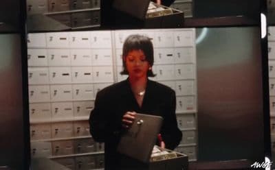 a woman standing in front of a bunch of boxes