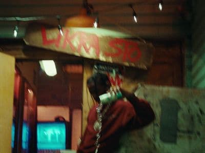 a man holding a skateboard over his head