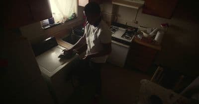 a man standing in a kitchen preparing food