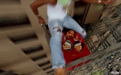 a woman standing on a balcony with a plate of food