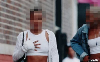a couple of women walking down a street