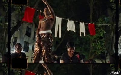 a man standing on top of a wooden pole