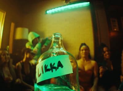 a bottle with a label on it with people in the background