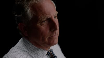 a man in a white shirt and blue tie