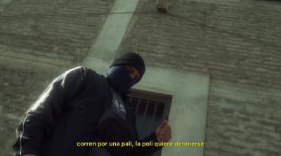a man wearing a black mask and a black jacket