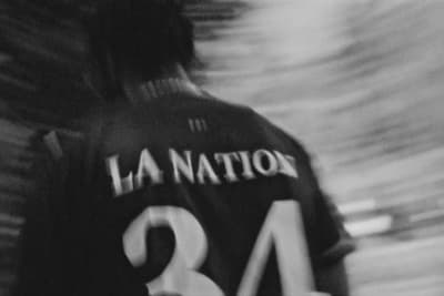 a black and white photo of a person wearing a jersey