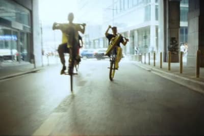 a couple of people riding bikes down a street