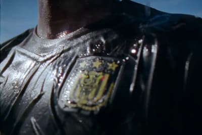 a close up of a man wearing a leather jacket