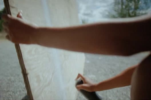 a person holding a skateboard in their hand