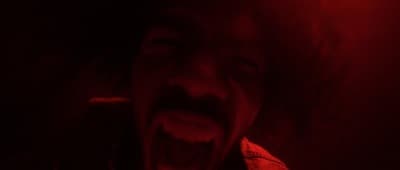 a person with their mouth open in a dark room