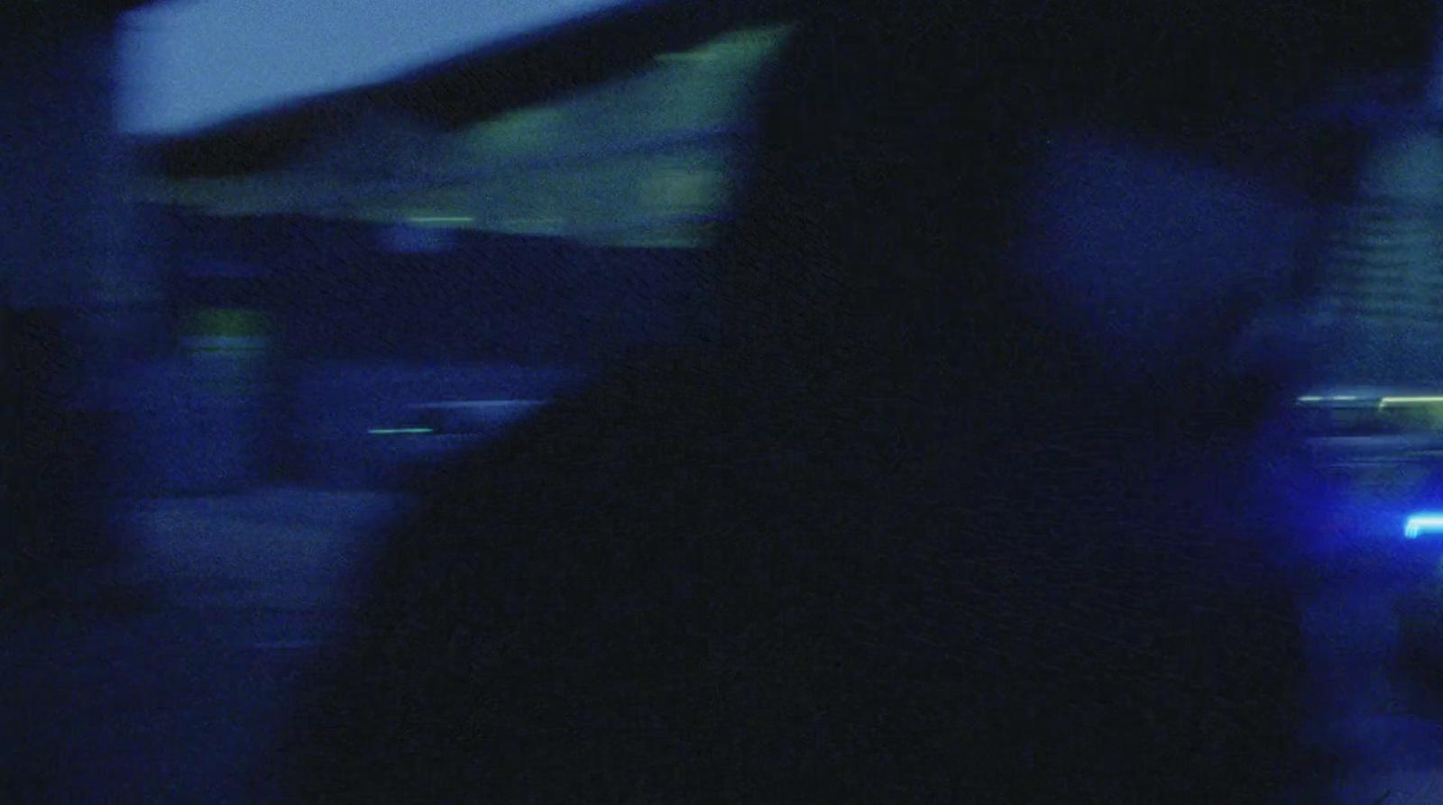 a blurry photo of a person walking down a street