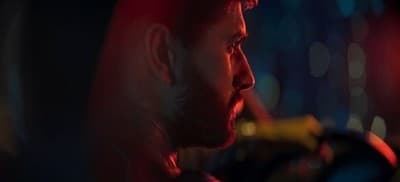 a man sitting in a car at night