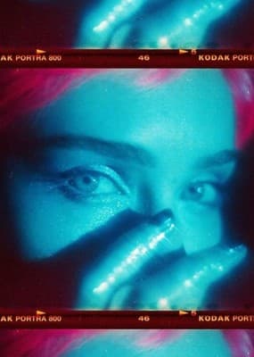 a woman's face with blue and pink hair