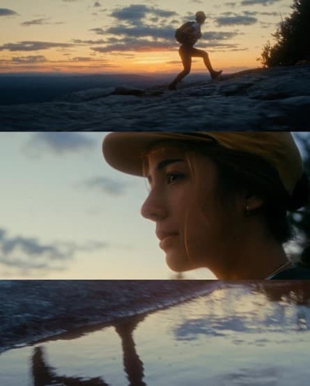 a woman walking on a beach next to the ocean