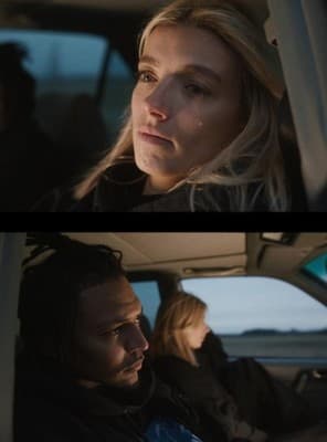 a man and a woman sitting in a car