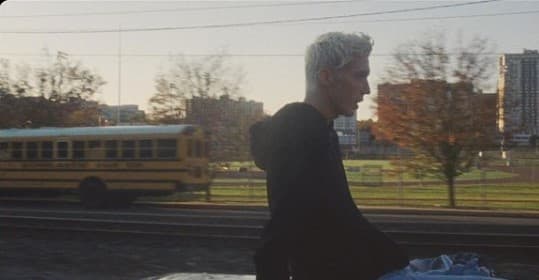 a man riding a bike next to a yellow school bus