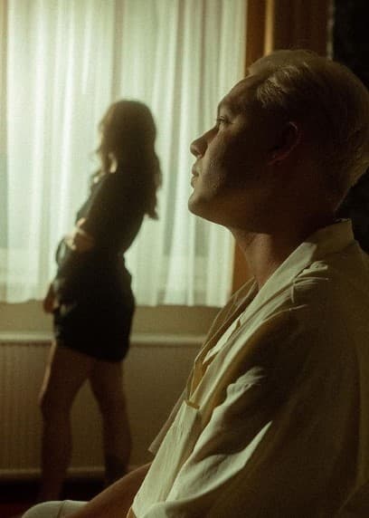 a man standing next to a woman in a living room