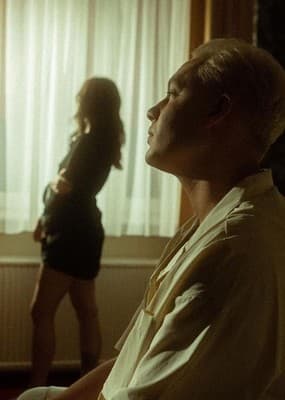 a man standing next to a woman in a living room