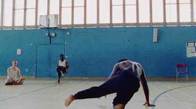 a group of young men playing a game of basketball