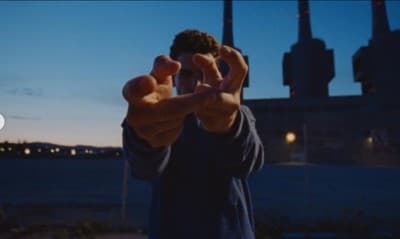 a man holding his hands up in the air
