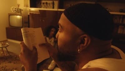 a man reading a book in a living room