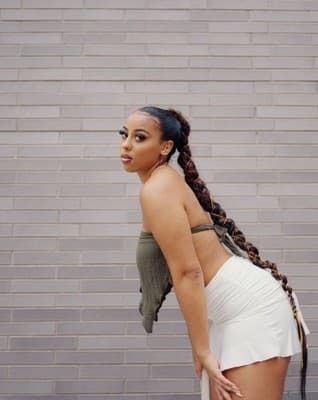 a woman in a short white skirt and a scarf