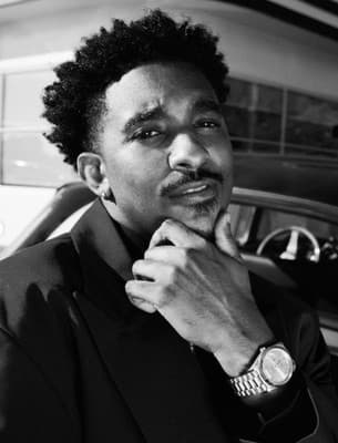 a black and white photo of a man in a suit