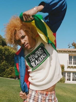 a man with red hair wearing a colorful jacket