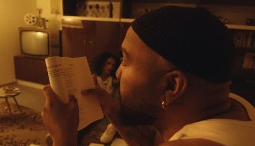a man reading a book in a living room